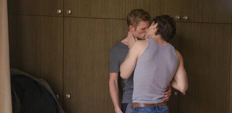 Two american boys beefy Justin Owen and young boy Ty Thomas love each other outdoor