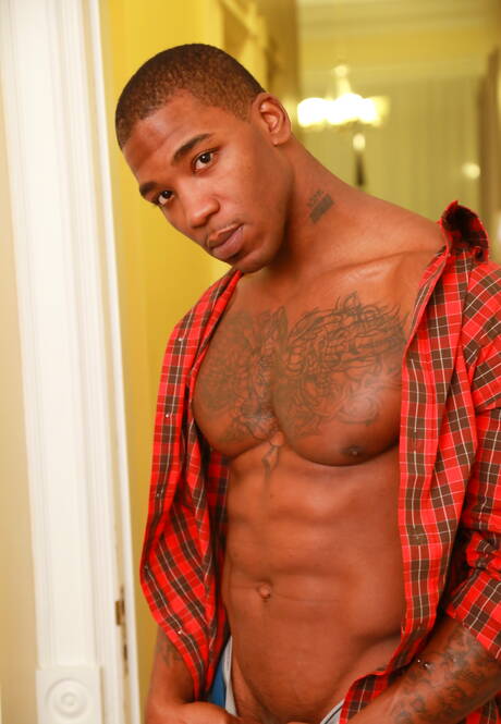 Black bodybuilder Mr Marvel undressing and showing his butt