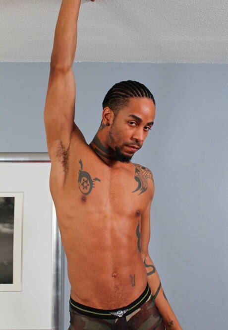 Ebony husky guy Jin Powers undressing and showing tight ass