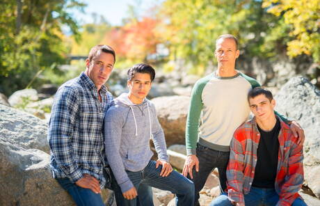 Hunk Nick Capra posing in jeans with young friends
