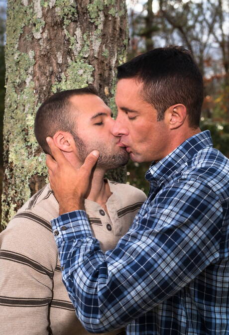Mature Nick Capra posing with hot young gays outdoors