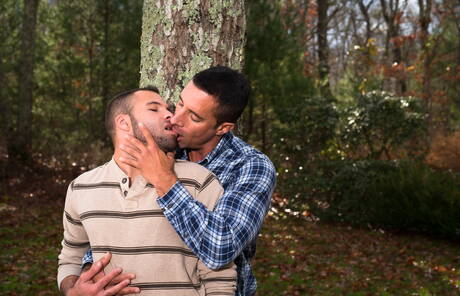 Mature Nick Capra posing with hot young gays outdoors