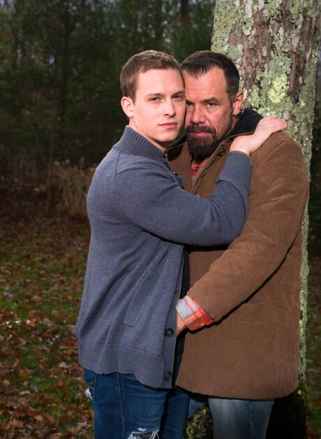 Mature Nick Capra posing with hot young gays outdoors