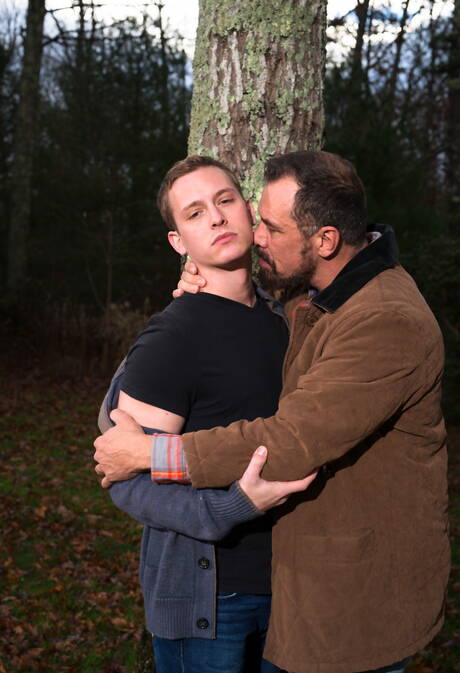 Mature Nick Capra posing with hot young gays outdoors