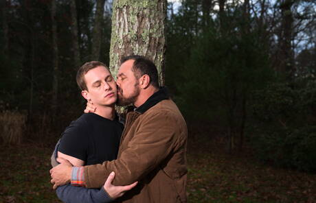 Mature Nick Capra posing with hot young gays outdoors