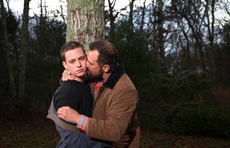 Mature Nick Capra posing with hot young gays outdoors