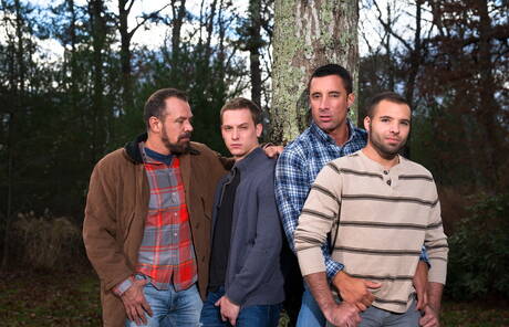 Mature Nick Capra posing with hot young gays outdoors