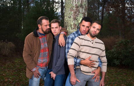 Mature Nick Capra posing with hot young gays outdoors