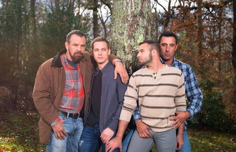 Mature Nick Capra posing with hot young gays outdoors