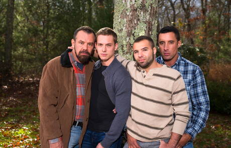 Mature Nick Capra posing with hot young gays outdoors