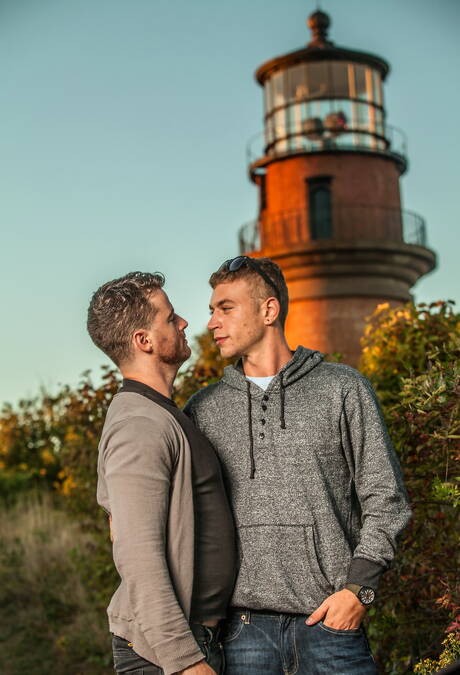 Amerikaanse otter Alexander Greene en Ierse harige beer Brendan Patrick poseren naakt op het strand