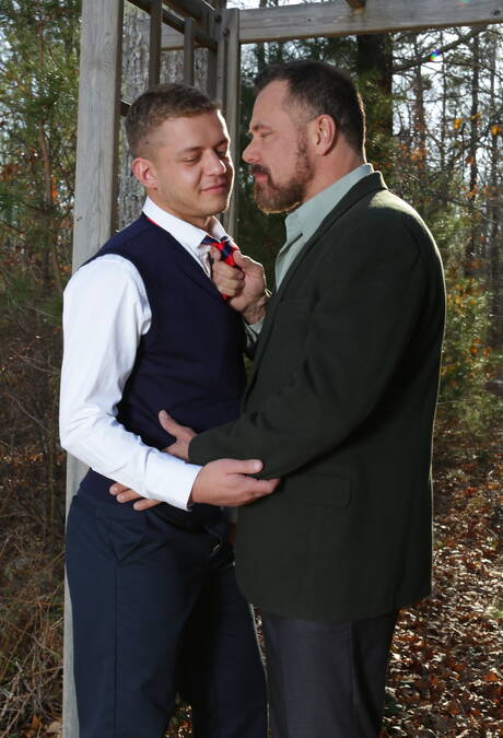 Young Ian Levine in glasses kissing with mature beard gays