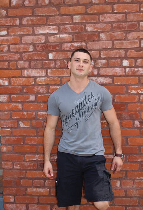 El hombre fuerte estadounidense Johnny Riley posando desnudo y mostrando su bonito trasero al aire libre