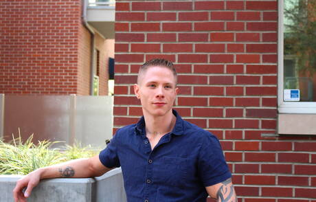 Muscular Guy Houston shows a muscle body outdoor