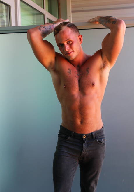 American hunk Zack Matthews shows a well-build body outside