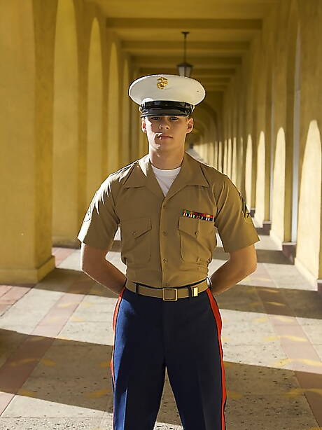 Well-built David posing nude outside