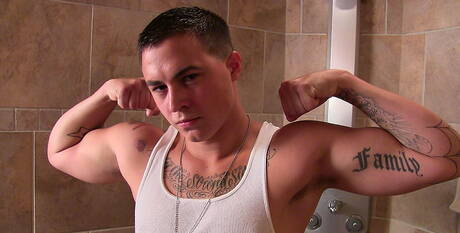 Muscular Grant shows a well-build body in bathroom