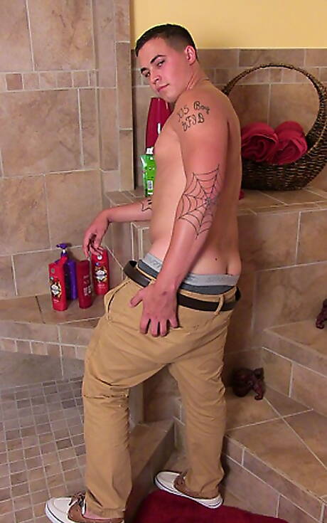 Muscular Grant shows a well-build body in bathroom