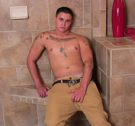 Muscular Grant shows a well-build body in bathroom