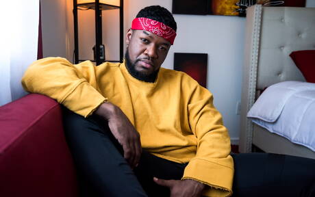 Noir Male: Black muscular Mr. Cali shows a husky body outdoor