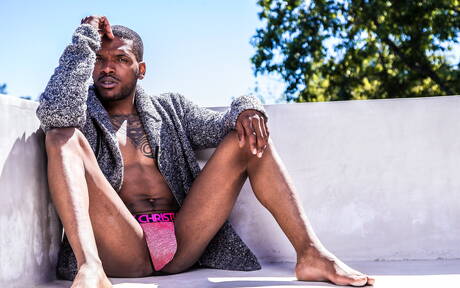 Black muscular Aaron Reese shows a husky body outdoor