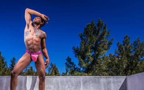 Black muscular Aaron Reese shows a husky body outdoor