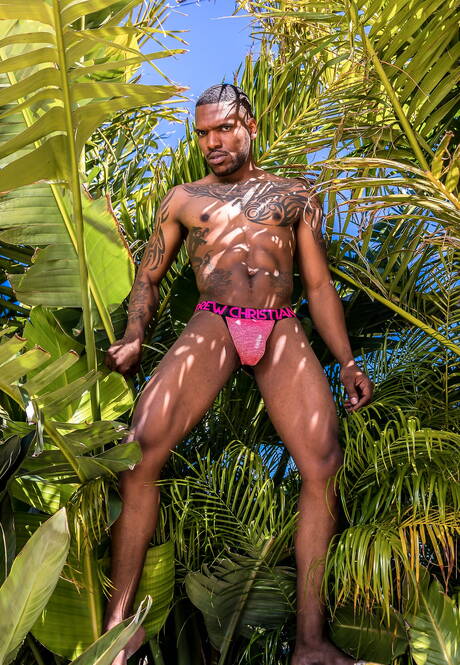 Black muscular Aaron Reese shows a husky body outdoor