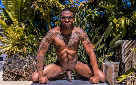Black muscular Aaron Reese shows a husky body outdoor