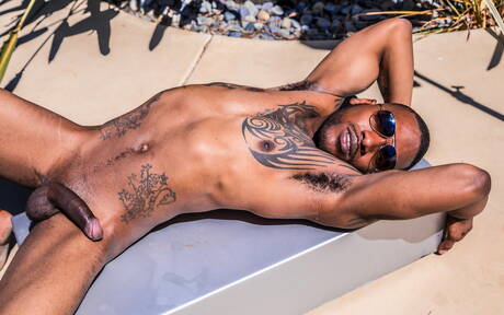 Black muscular Aaron Reese shows a husky body outdoor