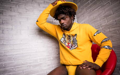 Ebony beefy Devin Trez shows a muscle body