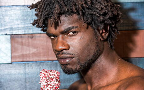 Noir Male: Ebony beefy Devin Trez shows a muscle body