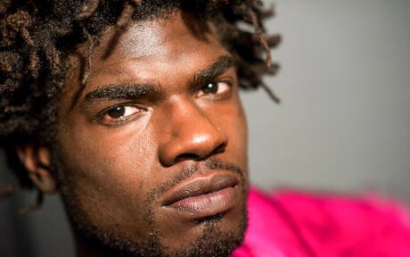 Ebony beefy Devin Trez shows a muscle body