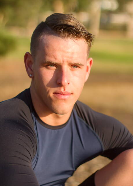 Der amerikanische Bodybuilder Shane Cook posiert nackt draußen