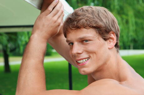 Muscular Clark Eckhart posing naked and showing tight butt outside