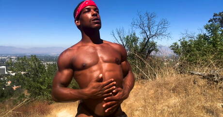 Black tough guy Adrian Hart jerking with toy outdoor
