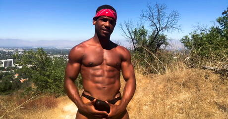 Black tough guy Adrian Hart jerking with toy outdoor