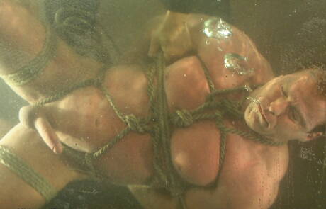 Strongman Derek Pain in bondage sex scene