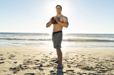 Husky guy Clyde shows a strong body on beach