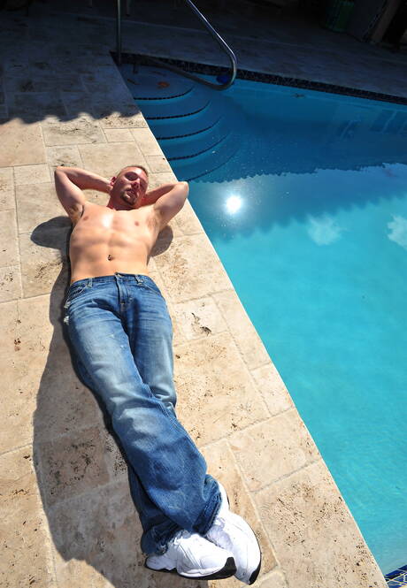 Black husky guy Izzy James and strongman Cole Mckenzie in black on white love on the beach