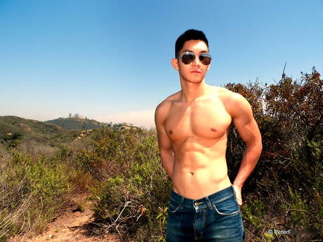 Oriental strong bull Eric East posing nude and showing tight ass outside