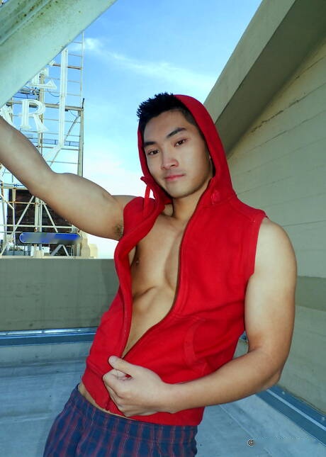 Asian muscular Eric East shows a perfect body outdoor