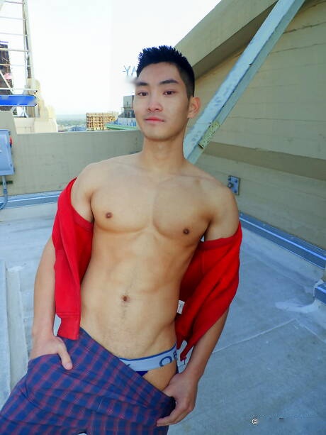 Asian muscular Eric East shows a perfect body outdoor