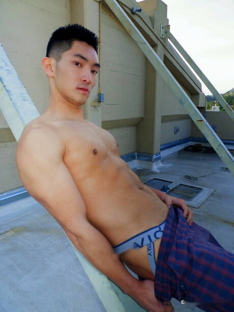 Asian muscular Eric East shows a perfect body outdoor
