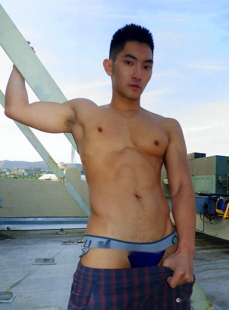 Asian muscular Eric East shows a perfect body outdoor