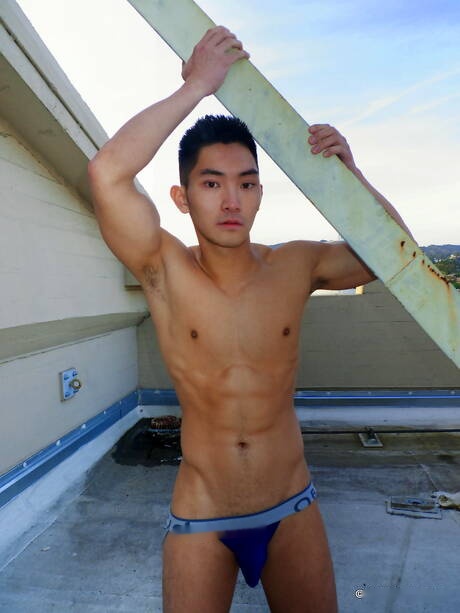 Asian muscular Eric East shows a perfect body outdoor