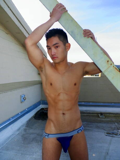 Asian muscular Eric East shows a perfect body outdoor