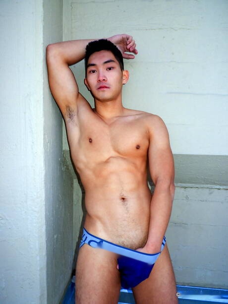 Asian muscular Eric East shows a perfect body outdoor