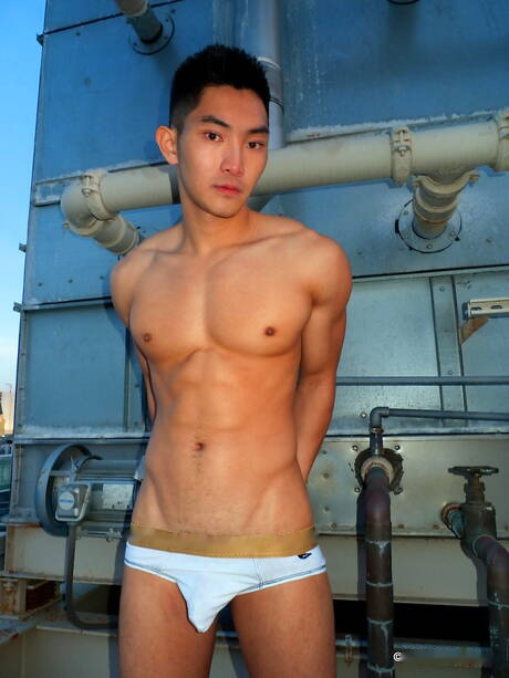 Asian strong bull Eric East posing naked outdoor