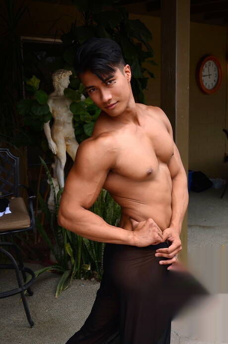 Oriental bodybuilder Ken Ott shows a sturdy body at pool