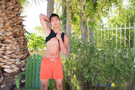 Oriental twink Alec Cruz posing nude and showing tight butt outdoor